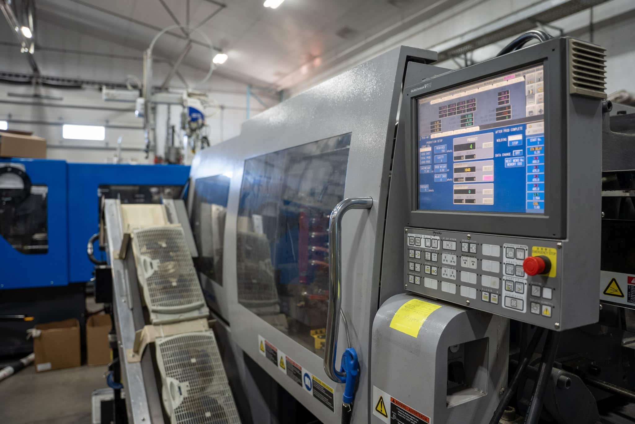 Injection Molding Machine Control panel of an injection molding machine used in plastic part production at Qualicase
